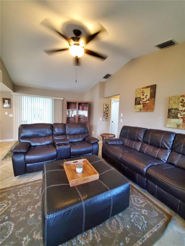 living room with ceiling fan, tile patterned floors, and vaulted ceiling