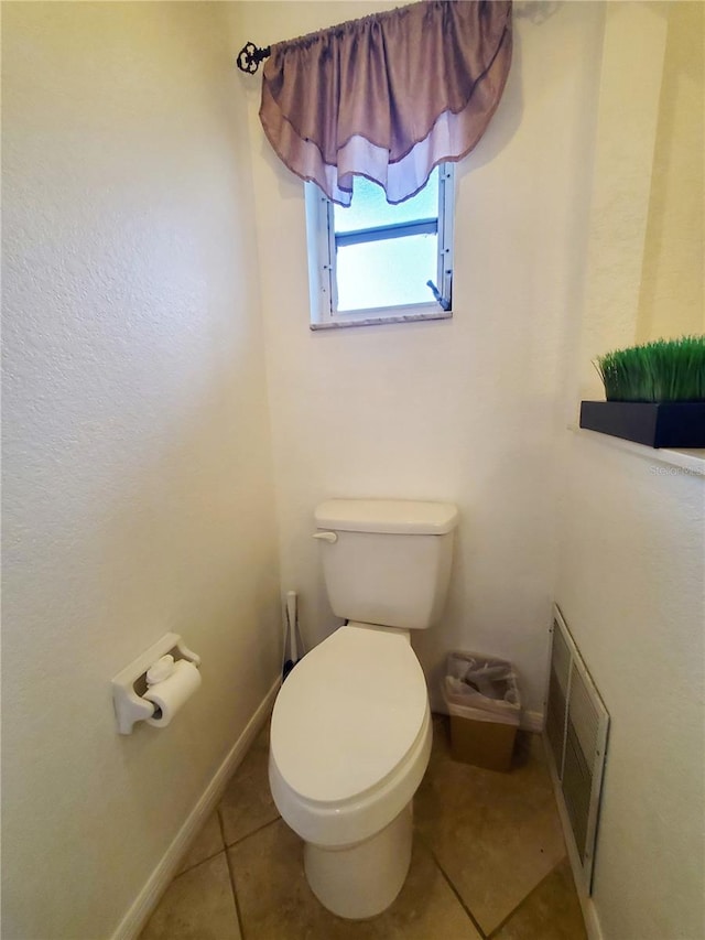 bathroom with toilet and tile patterned flooring