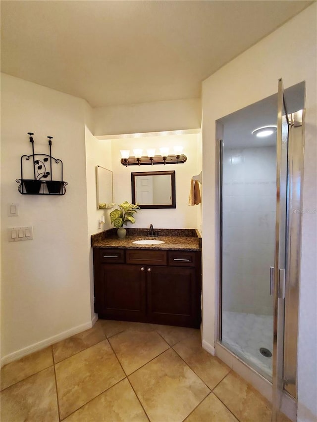 bathroom featuring vanity, a shower with shower door, and tile patterned floors