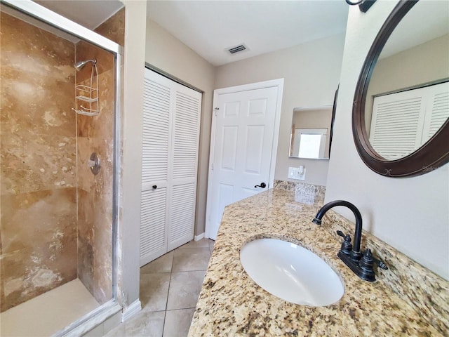 bathroom with vanity, walk in shower, and tile patterned flooring