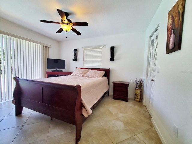 tiled bedroom featuring a closet, multiple windows, and ceiling fan