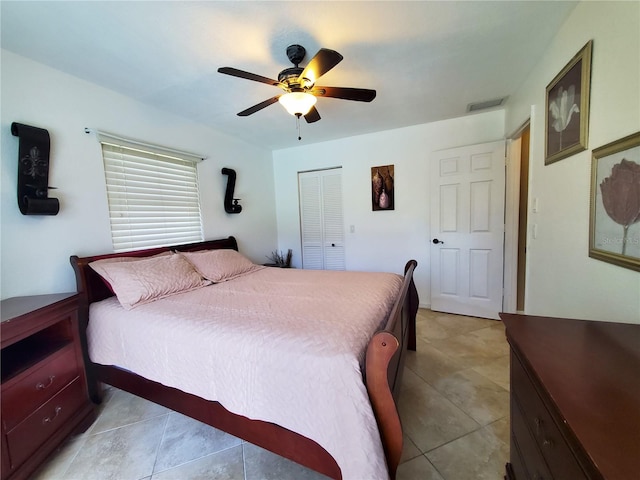 bedroom featuring a closet, ceiling fan, and light tile patterned floors