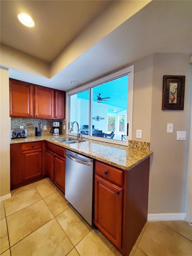 509 Clearview Dr, Port Charlotte, FL 33953 - kitchen with stainless steel dishwasher, a sink, light stone countertops, baseboards, and backsplash