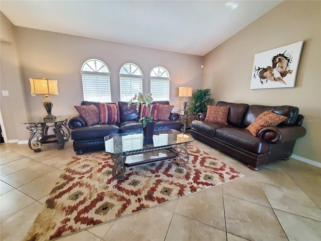 living room featuring lofted ceiling and tile patterned flooring