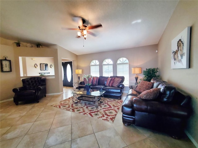 tiled living room with ceiling fan and vaulted ceiling