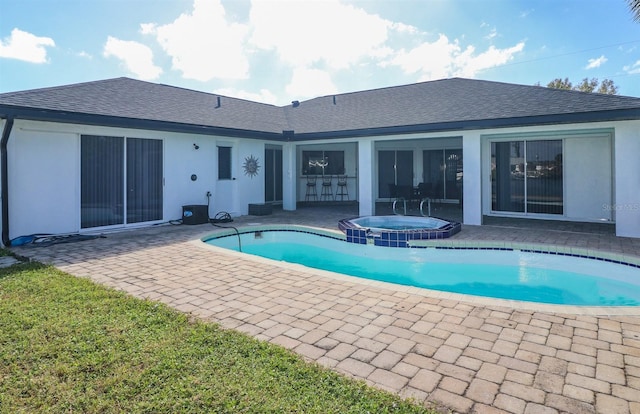 view of pool featuring a patio area and an in ground hot tub