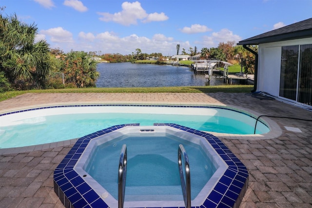 view of swimming pool with a water view and an in ground hot tub