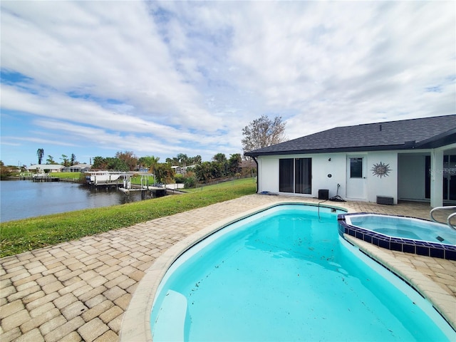 view of swimming pool featuring a patio and a water view