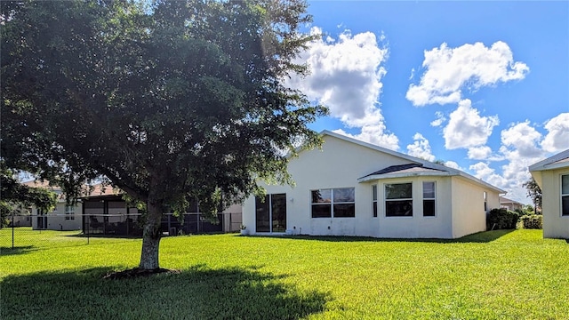 rear view of house with a lawn