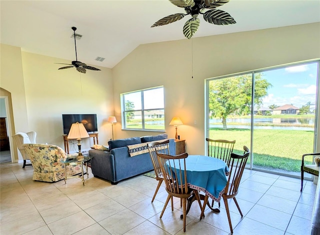 dining space with ceiling fan, high vaulted ceiling, and light tile patterned floors