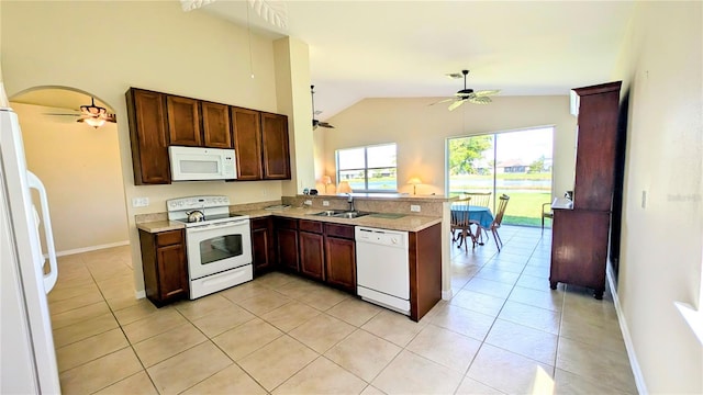 kitchen with white appliances, light tile patterned flooring, sink, kitchen peninsula, and lofted ceiling