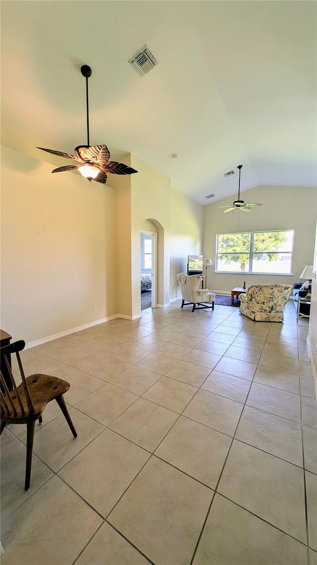 interior space with light tile patterned floors, vaulted ceiling, and ceiling fan