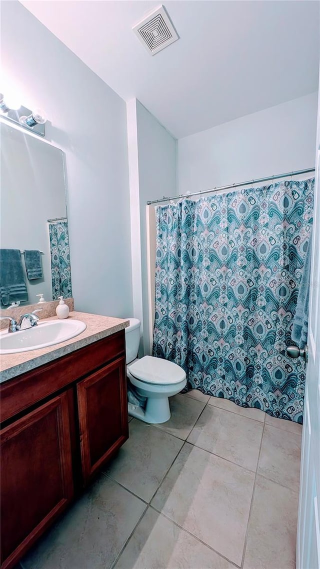 bathroom featuring vanity, toilet, tile patterned floors, and a shower with shower curtain