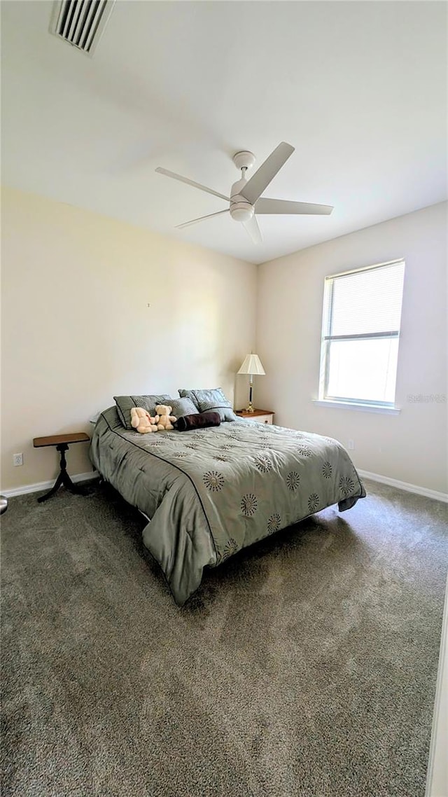 bedroom with ceiling fan and dark colored carpet