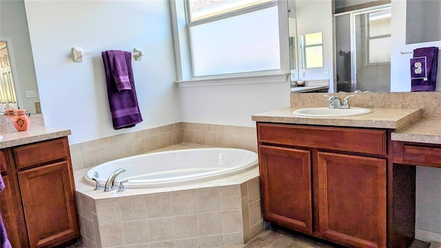 bathroom with vanity, separate shower and tub, and plenty of natural light