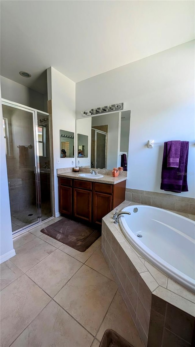 bathroom with vanity, tile patterned floors, and separate shower and tub