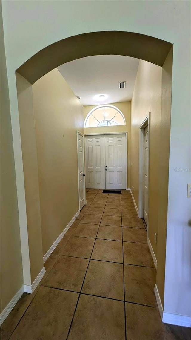 doorway with tile patterned flooring