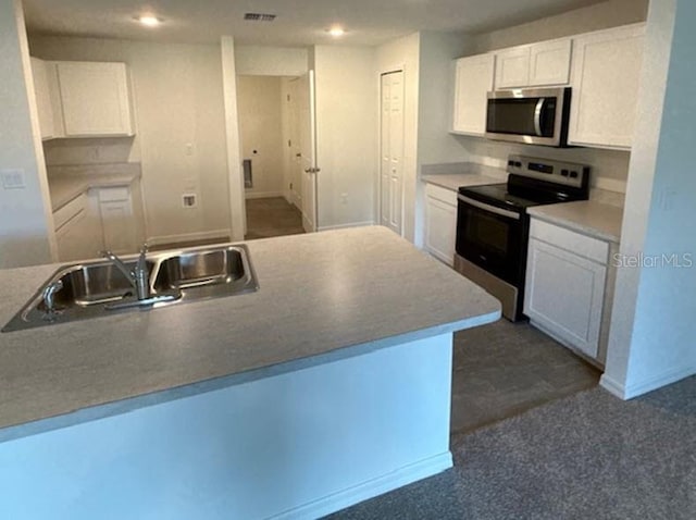40 Perkins Ln, Palm Coast, FL 32164 - kitchen featuring visible vents, recessed lighting, white cabinets, a sink, and appliances with stainless steel finishes