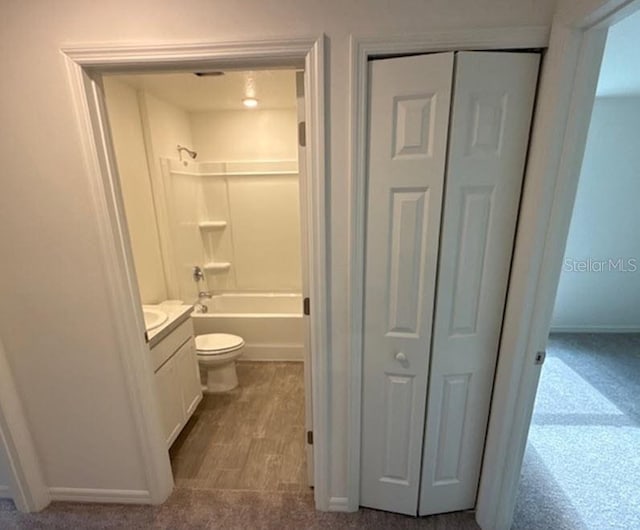 full bathroom featuring vanity, hardwood / wood-style floors, toilet, and shower / bath combination