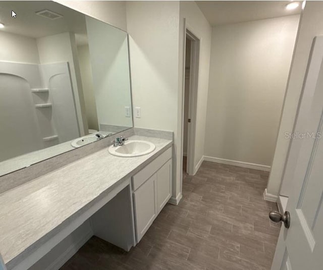 bathroom with vanity and wood-type flooring