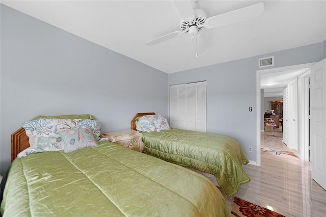 bedroom with hardwood / wood-style flooring, a closet, and ceiling fan