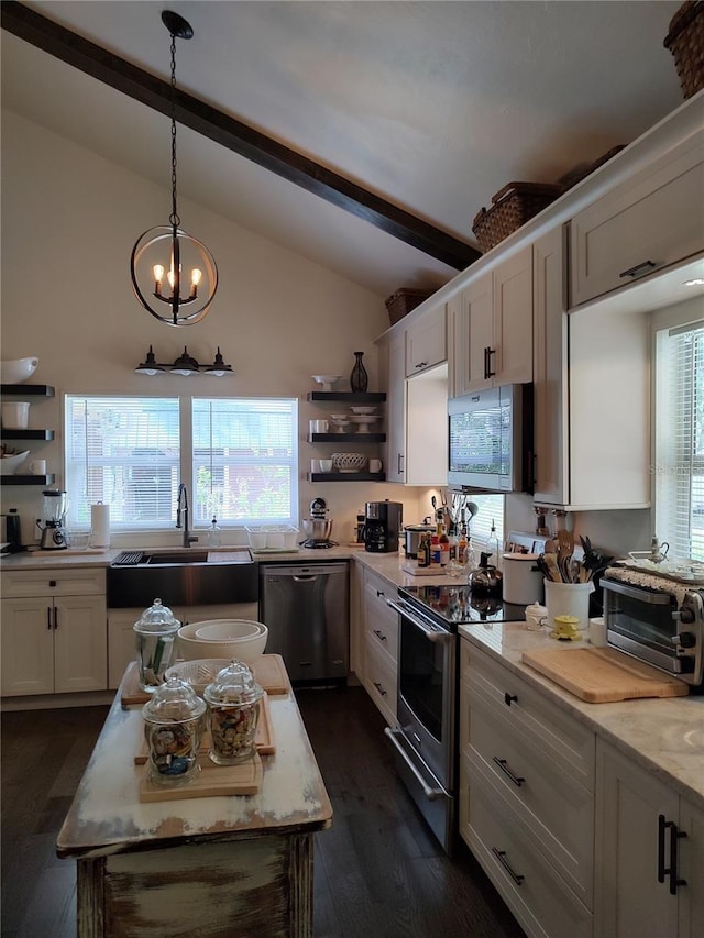 kitchen featuring dark hardwood / wood-style flooring, appliances with stainless steel finishes, vaulted ceiling with beams, and plenty of natural light