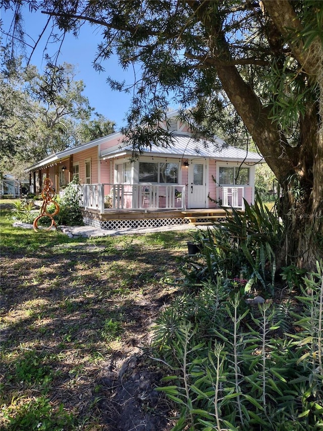 rear view of house with central AC and a porch