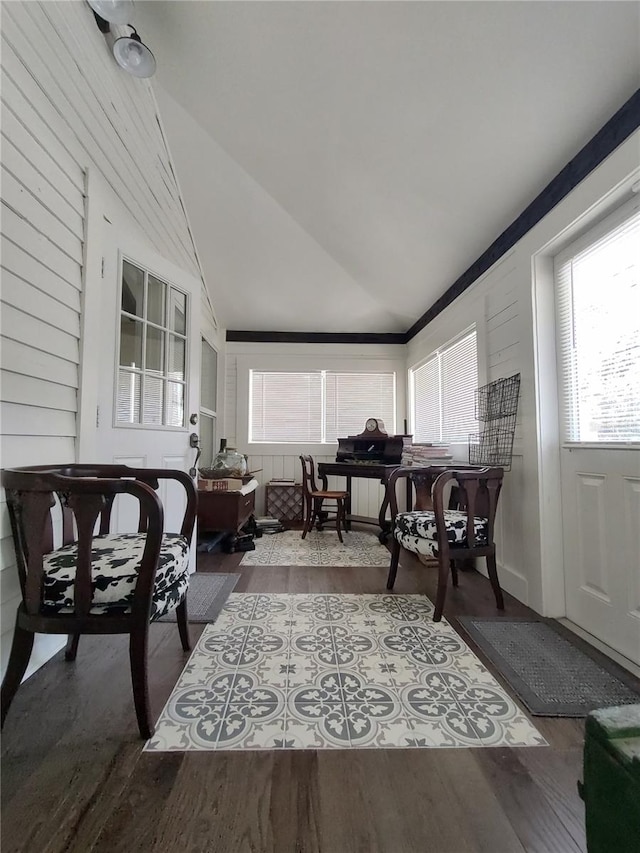 living room featuring vaulted ceiling and hardwood / wood-style floors