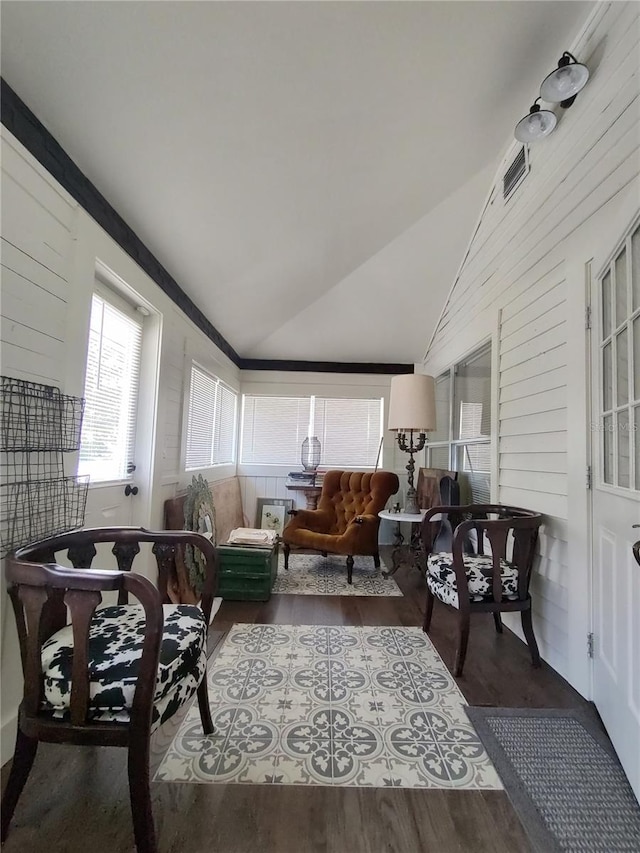 interior space with hardwood / wood-style flooring and lofted ceiling