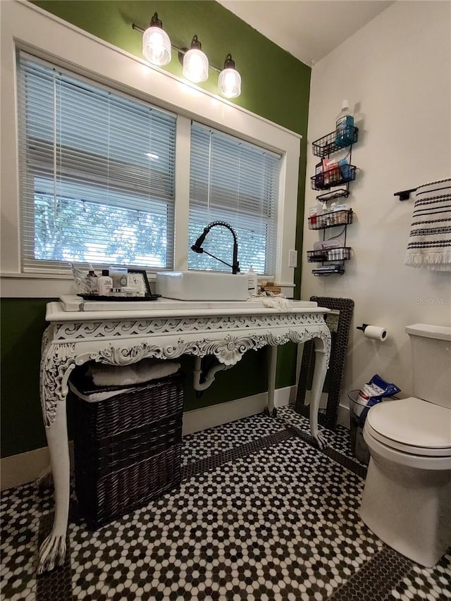 bathroom featuring toilet and tile patterned flooring