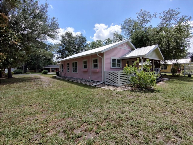 view of side of home with a lawn