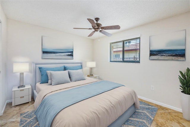 bedroom featuring ceiling fan and a textured ceiling