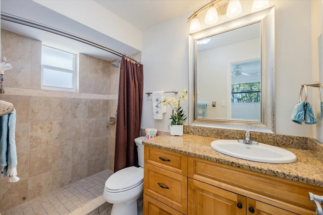 bathroom featuring walk in shower, a wealth of natural light, vanity, and toilet