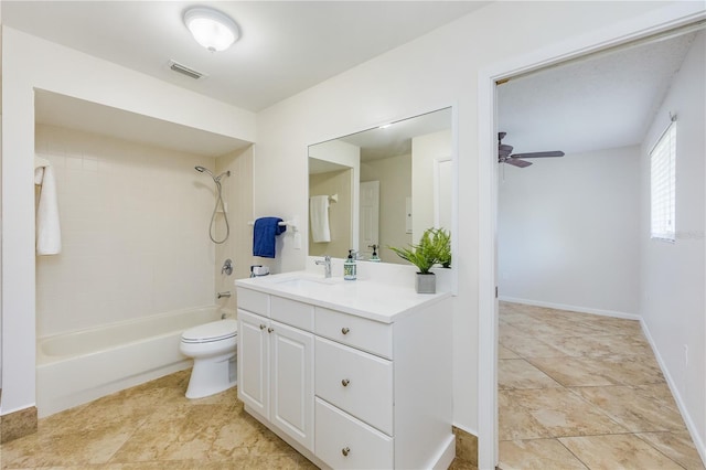 full bathroom with ceiling fan, vanity, toilet, and tiled shower / bath combo