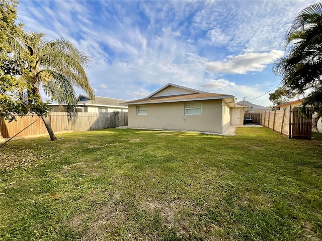 back of house with a yard