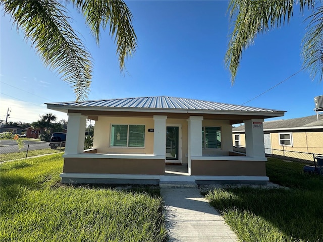 view of front of home with covered porch and a front yard