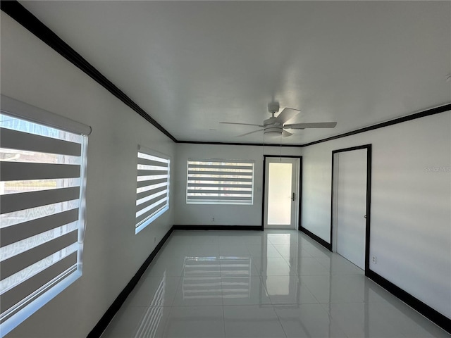 tiled spare room with ceiling fan and ornamental molding