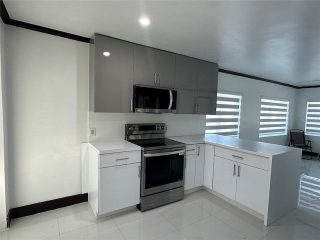 kitchen featuring gray cabinetry, kitchen peninsula, appliances with stainless steel finishes, light tile patterned floors, and ornamental molding