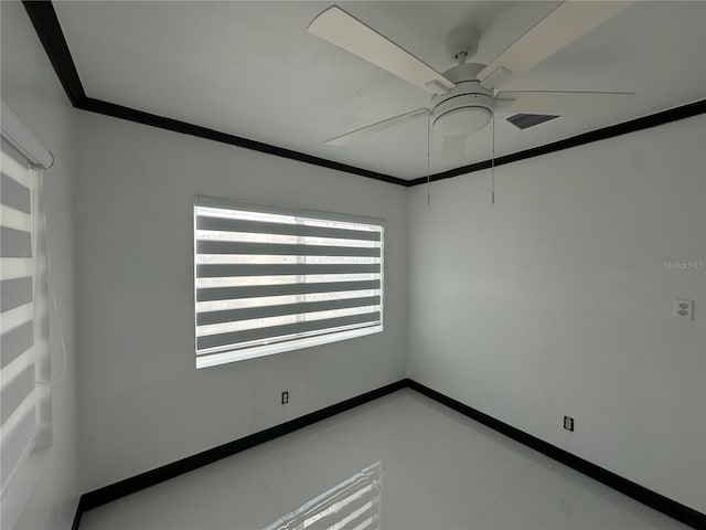 spare room with ceiling fan and crown molding