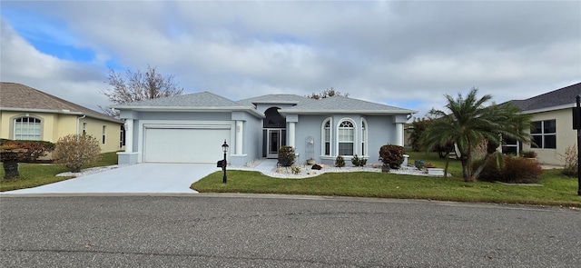 ranch-style house featuring a front lawn and a garage