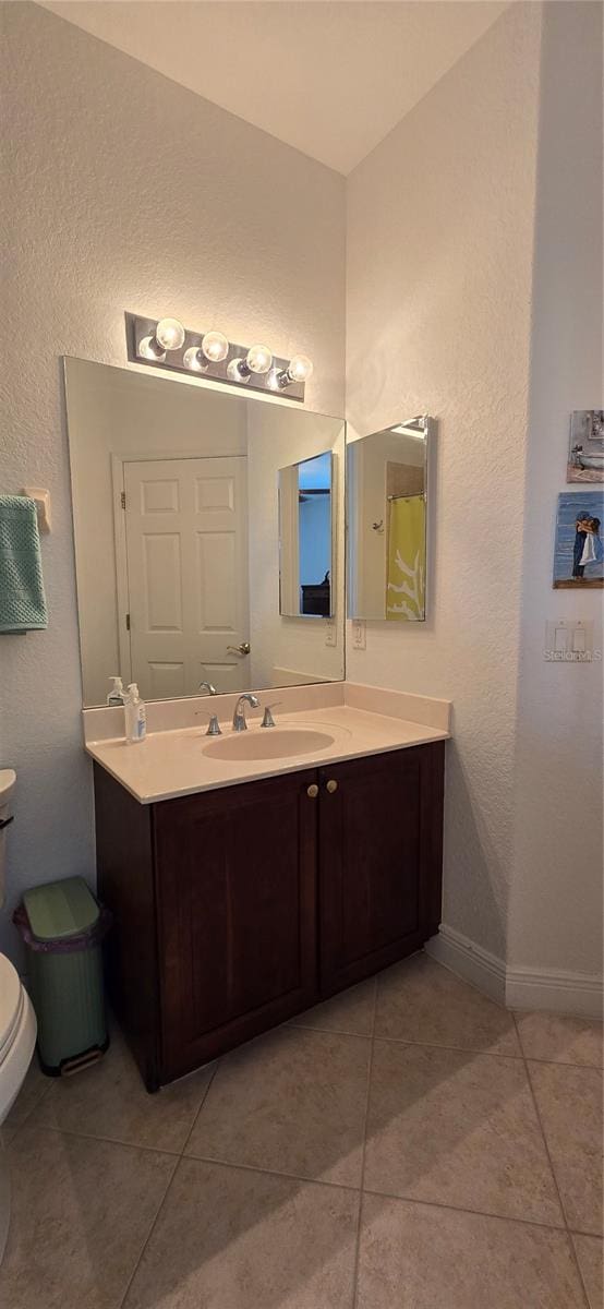 bathroom featuring vanity, toilet, and tile patterned floors