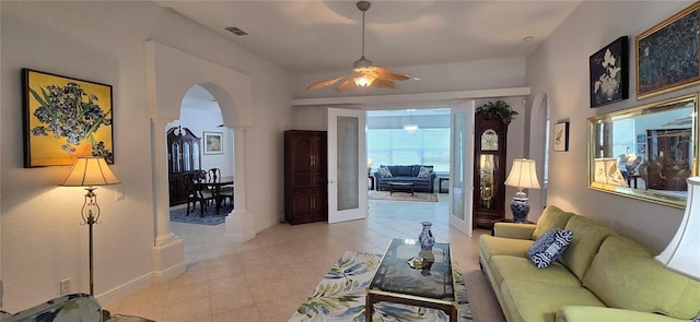 living room featuring ceiling fan and decorative columns