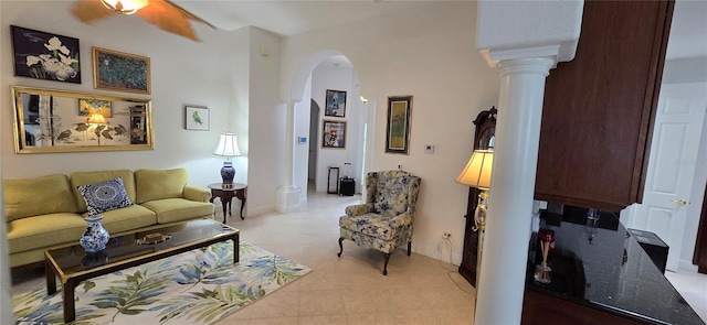 living room with ornate columns, light tile patterned floors, and ceiling fan