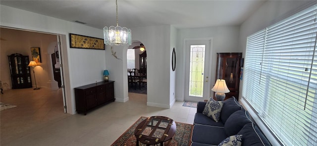 living room featuring a wealth of natural light and an inviting chandelier