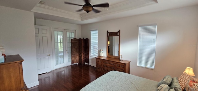 bedroom featuring dark hardwood / wood-style flooring, access to outside, ceiling fan, and a raised ceiling