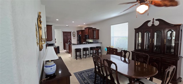 dining area featuring light tile patterned floors and ceiling fan