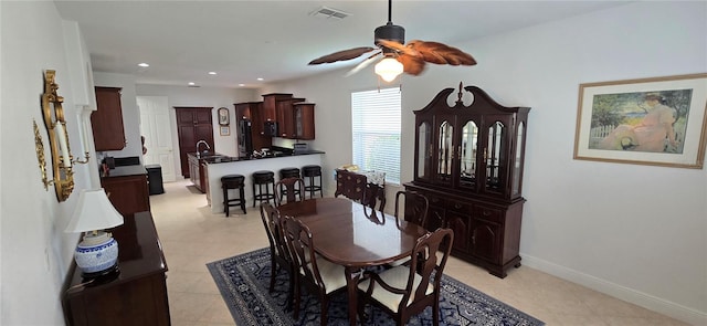 dining space featuring ceiling fan and light tile patterned flooring