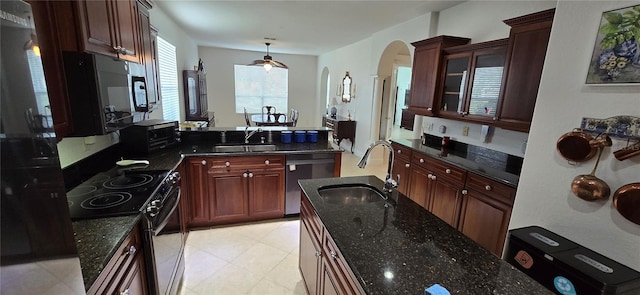 kitchen featuring range with electric cooktop, sink, stainless steel dishwasher, and decorative light fixtures