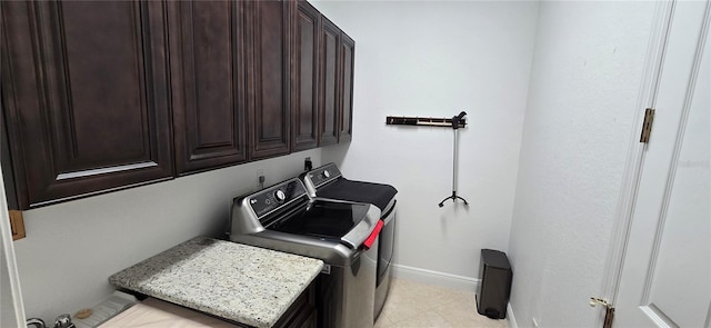 washroom with cabinets and washing machine and dryer