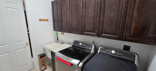 washroom with cabinets and washer and clothes dryer